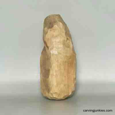 Painted left side of wood carved pear caricature