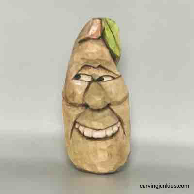Painted front of wood carved pear caricature