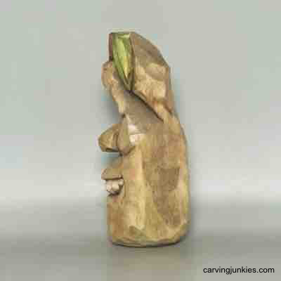 Painted left side of wood carved pear caricature