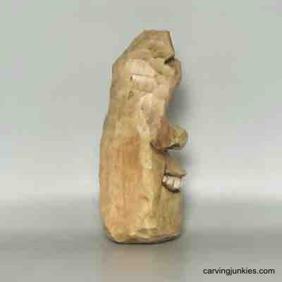 Painted right side of wood carved pear caricature