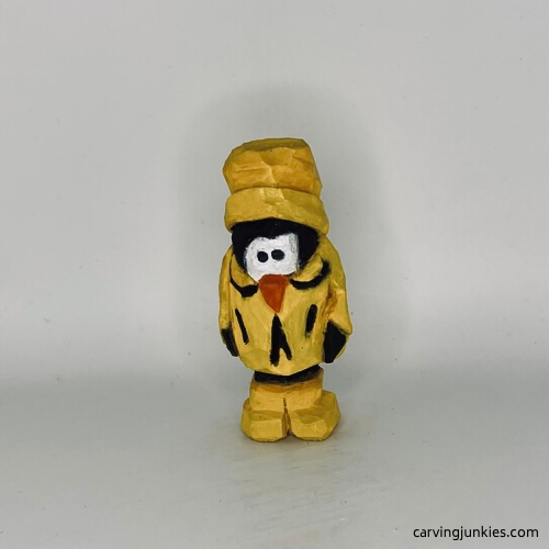 Front view of painted wood carved penguin