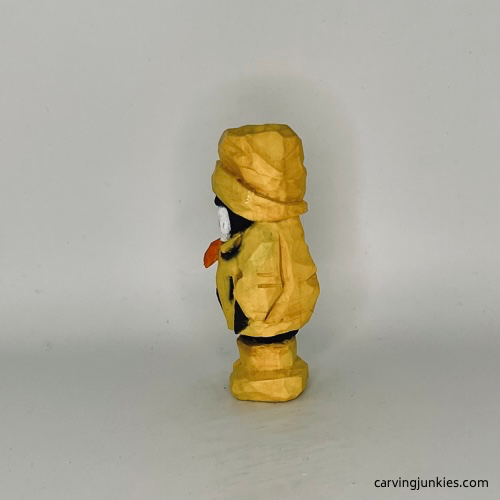 Left view of painted wood carved penguin