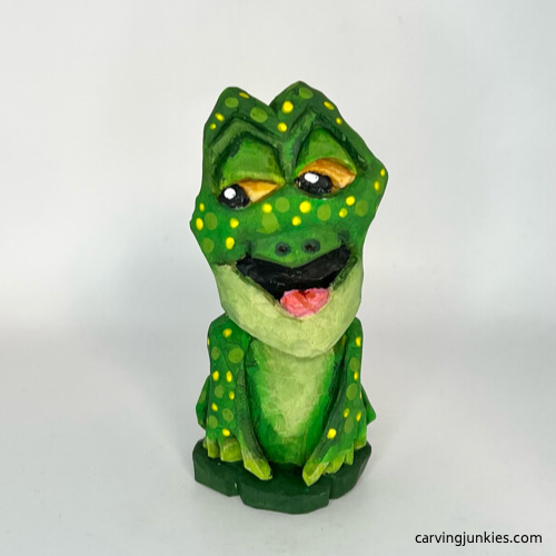 Front of painted wooden frog carving