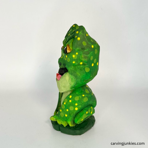 Left side of painted wooden frog carving