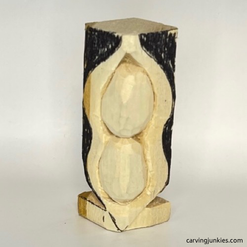 Carved base in progress on pea pod wood carving Bottom of carved base on pea pod wood carving