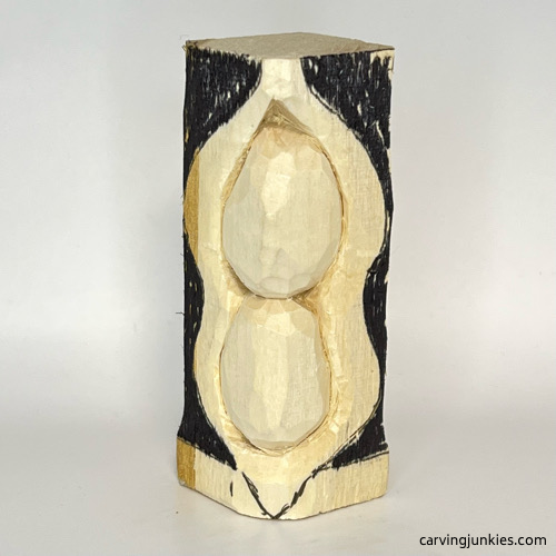 Colored wood for removal on pea pod wood carving Marked wood for removal on pea pod wood carving