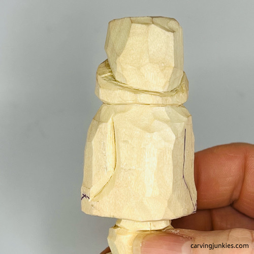 Separated arms on carved wood penguin