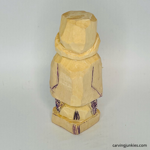 Wood marked for removal on back of penguin