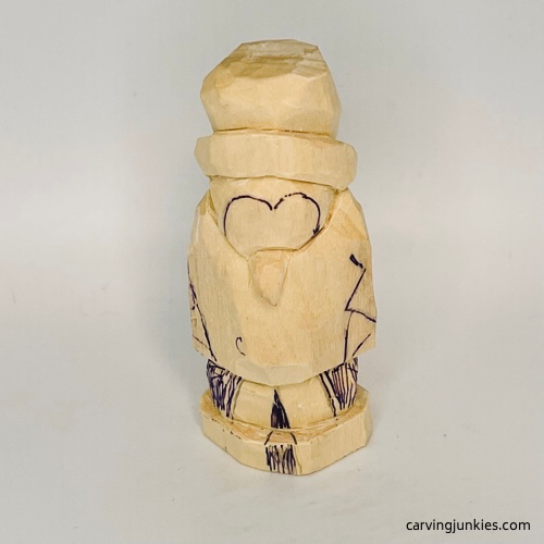 Marked wood for removal on carved penguin