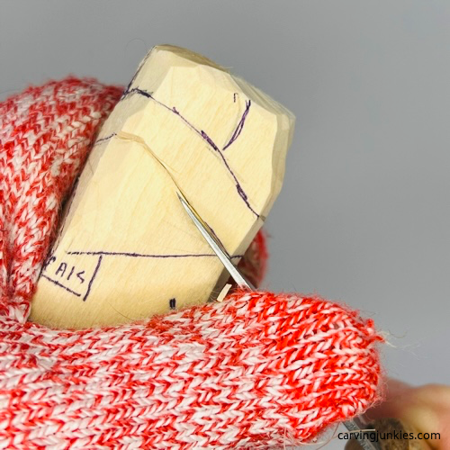 Separating hat on carved penguin