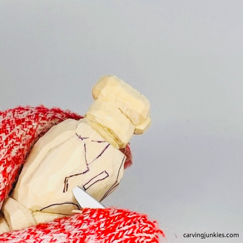 Making a pyramid cut on carved wood penguin