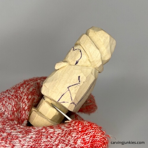 Separating boots on wood carved penguin