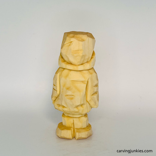 Back view of unpainted wood carved penguin