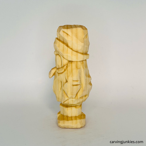 Left view of unpainted wood carved penguin