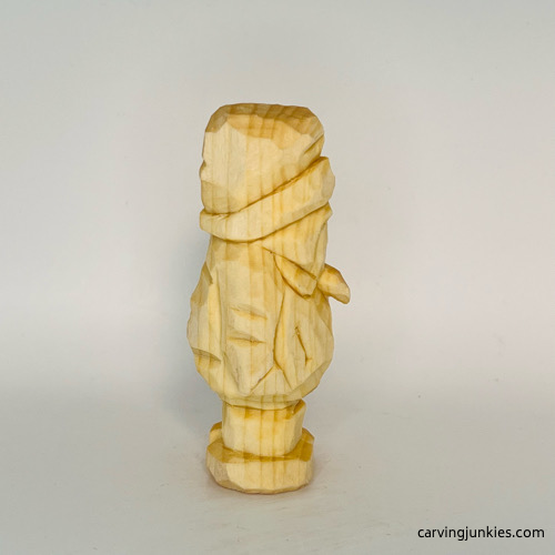 Right view of unpainted wood carved penguin