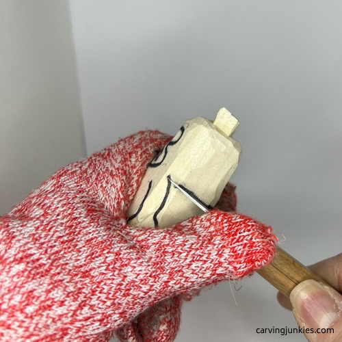 Making stop cut to carve wood pig