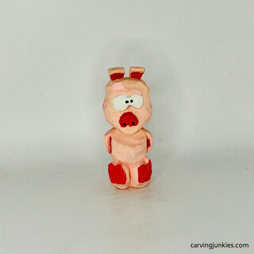 Front view of painted wood pig