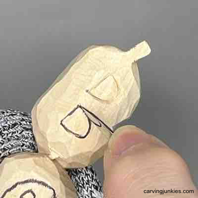 Carving the letters on pumpkin wood carving