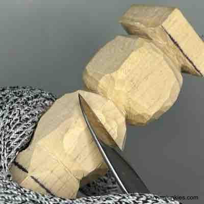 Shaping the back of a pumpkin wood carving