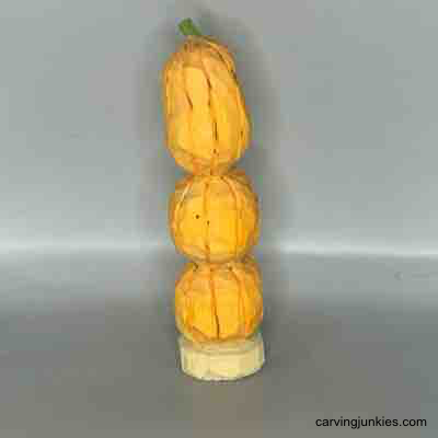 Back view of wood carved pumpkins painted