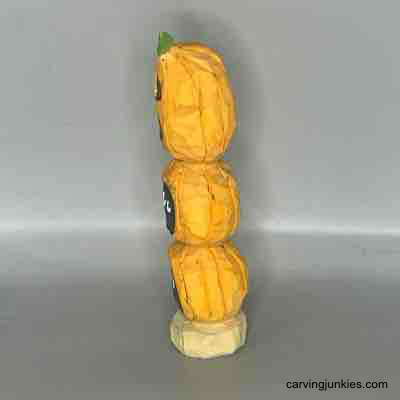 Left view of wood carved pumpkins painted