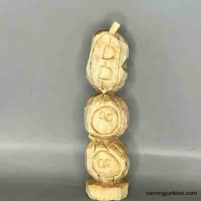Front of unpainted wood pumpkin carvings
