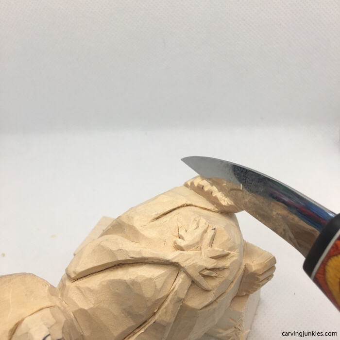 Cutting raccoon carving with knife