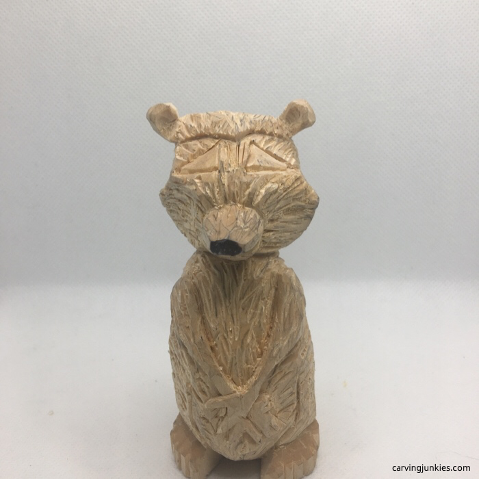 Adding eyes to wooden raccoon