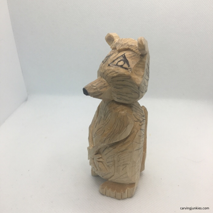 Left side of fur lines on wooden raccoon