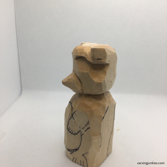 Left view of wood raccoon carving