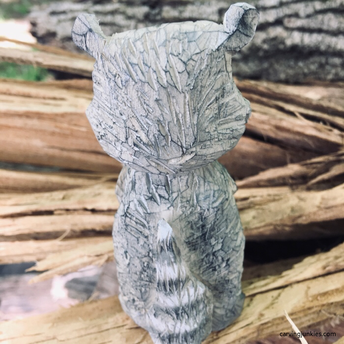 Back view of raccoon carving