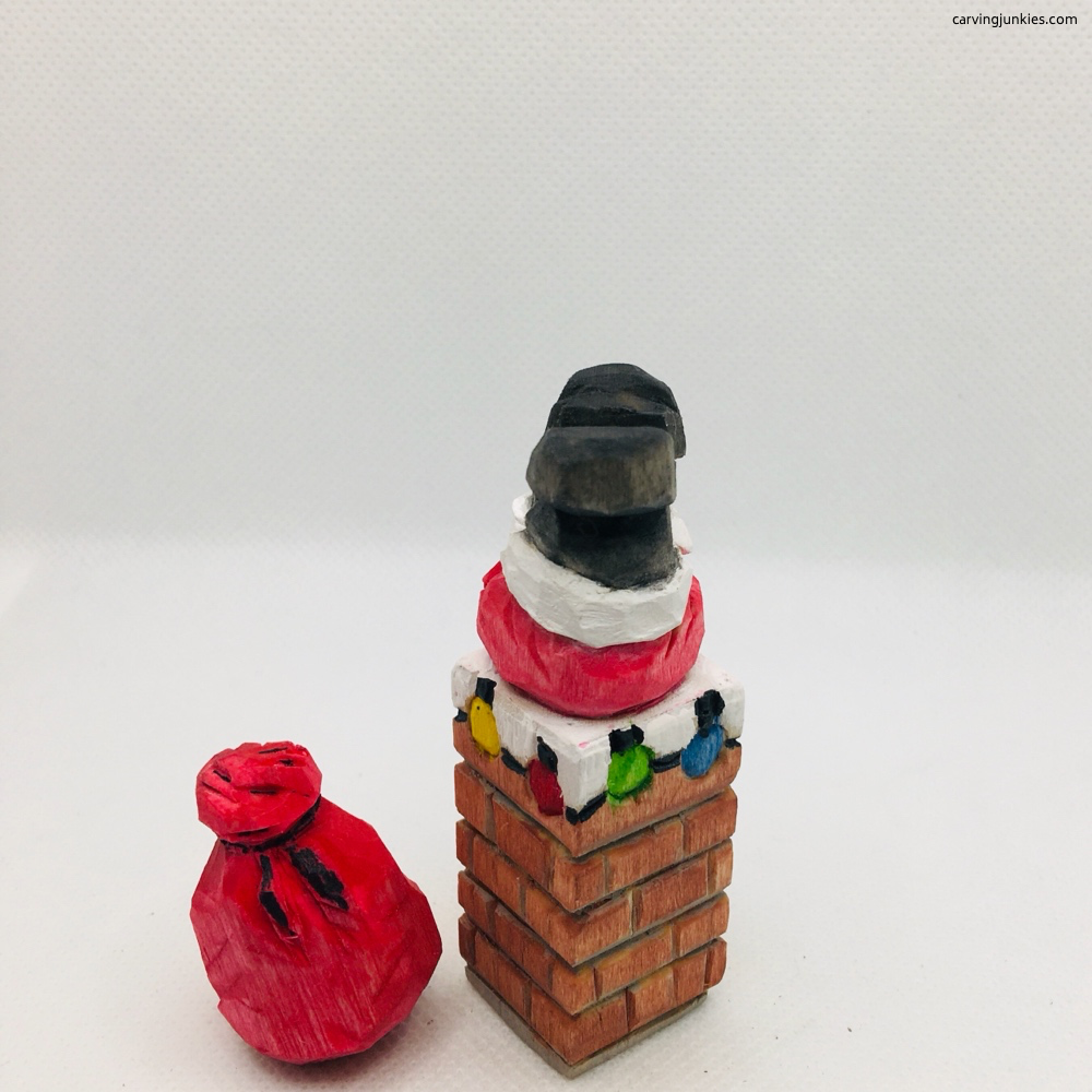 Painted wood carved Santa stuck in the chimney