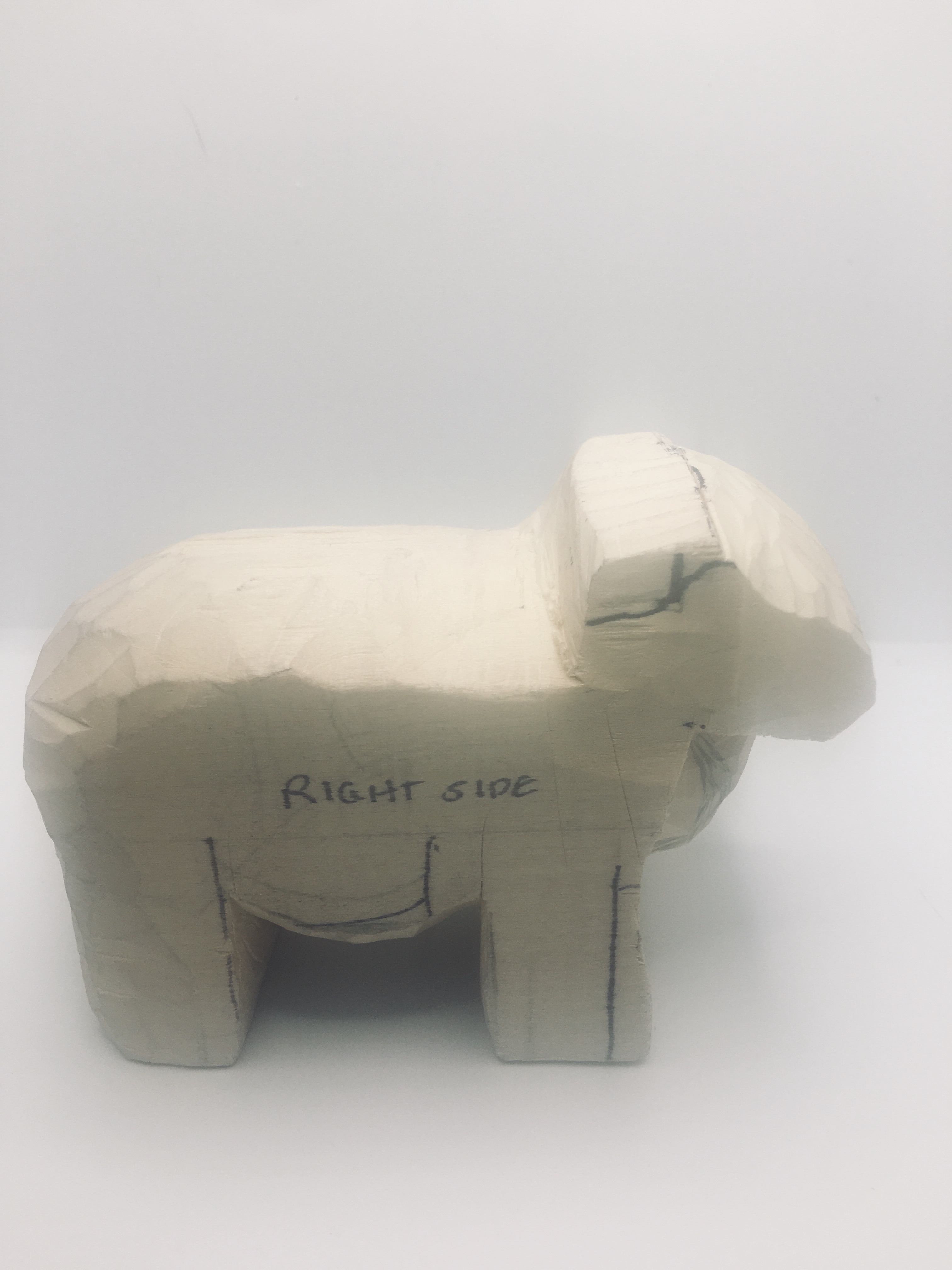 Carving wood sheep belly