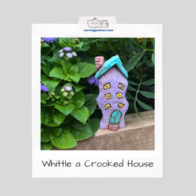 Cute purple and turquoise crooked house wood carving