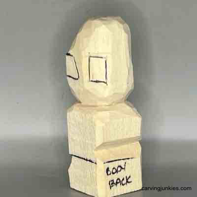 Create a whimsical little wood sculpture with our tutorial. Left ear box sketched on small guy wood carving