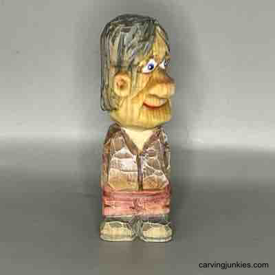 Unleash your creativity and carve a delightful little wooden figure today! Painted front of small guy wood carving