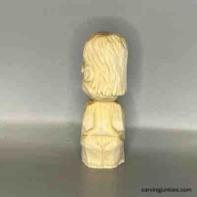 Follow our guide to craft a whimsical tiny wood character. Back view of unpainted small guy wood carving