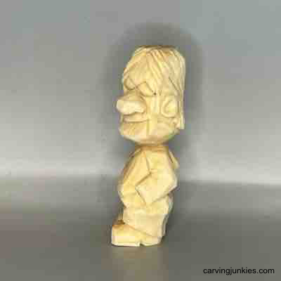Learn to make an adorable little wood sculpture. Left view of unpainted small guy wood carving