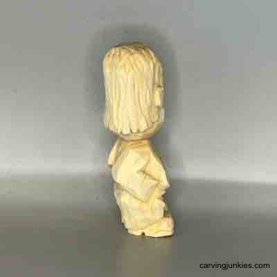 Create a unique small wooden person with our step-by-step guide. Right view of unpainted small guy wood carving