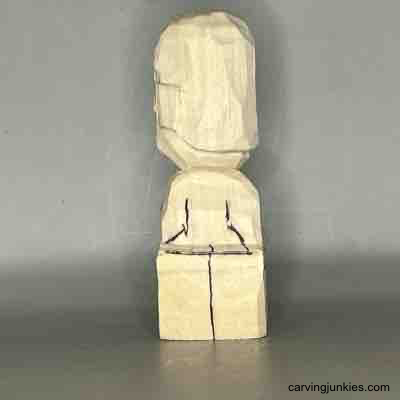 Craft a whimsical little figure from wood with our guide. Back view of details on small guy wood carving