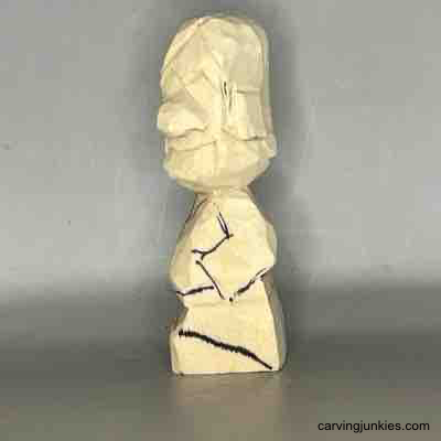 Master the skills to create a miniature wooden character. Details on the left side of small guy wood carving