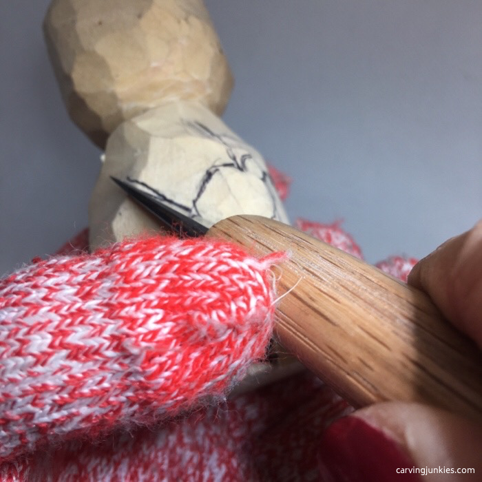 Cutting arms on wooden snowman