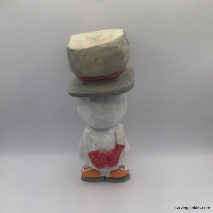 Back view of painted wood snowman carving
