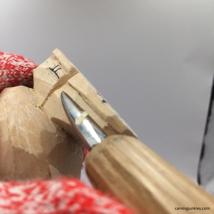 Shaping skates on wood carved snowman