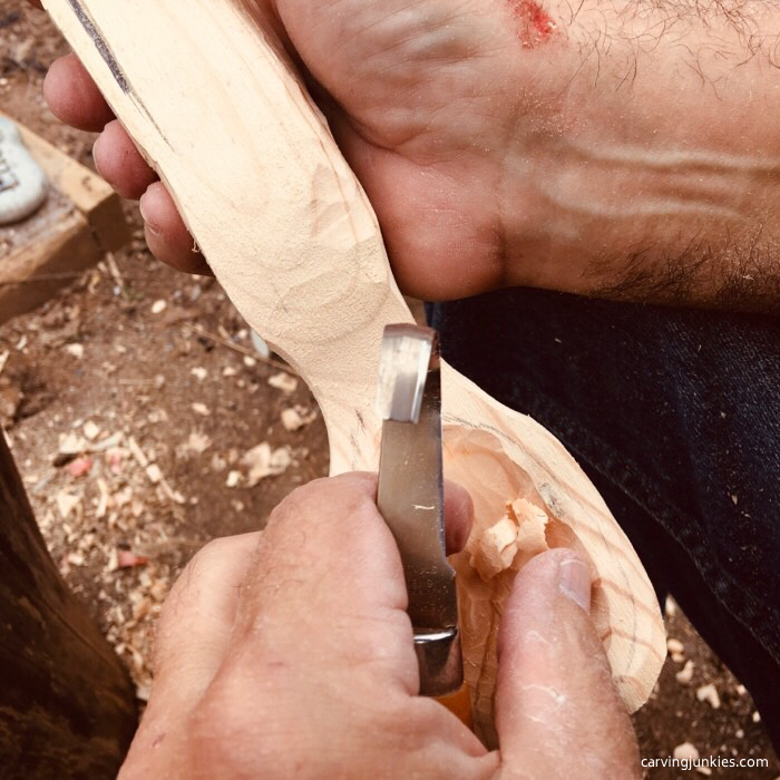 Hook knife in use to make a spoon
