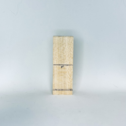 Front guidelines on tiny wood carving man