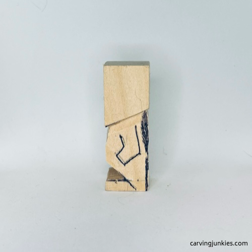 Left arm is sketched on tiny wood carving man