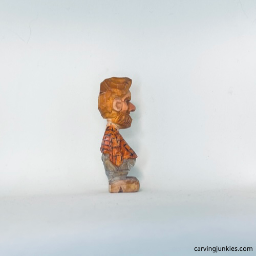 Painted right view of tiny wood carving man