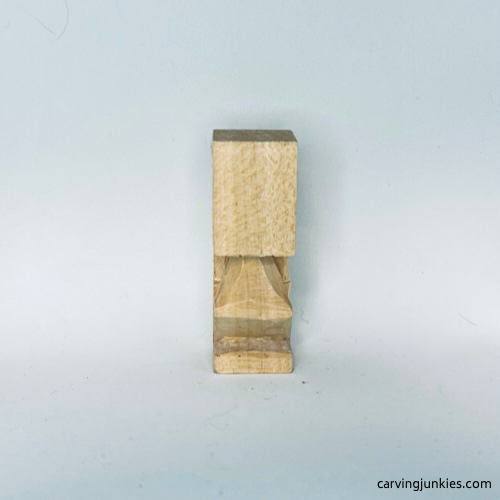 Progress photo of tiny wood carving man