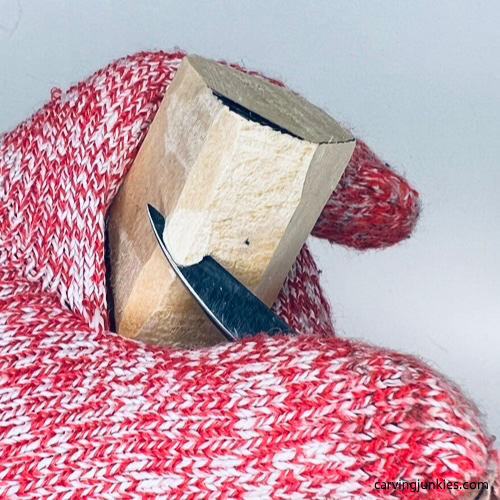 Removing wood to shape face on tiny wood carving